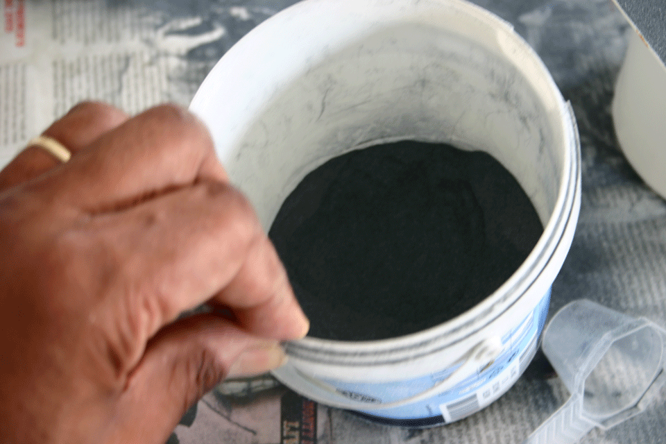 Carborundum powder in a plastic storage tub